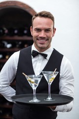 Waiter with tray of cocktails