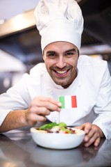 Handsome chef presenting meal with italian flag