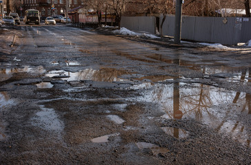 bad road with holes and puddles