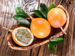 Granadilla fruits on the wooden table.