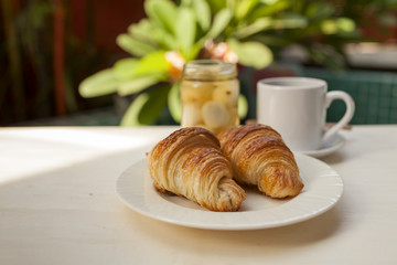 French croissant with coffee in the garden