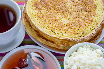 Pancakes with strawberry jam, cheese and cup of tea