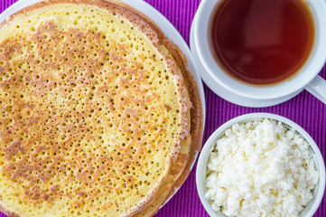 Pancakes with cheese and a cup of tea