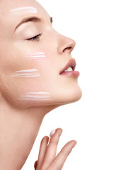 Fototapeta na wymiar Beautiful Young Woman applying facial moisturizing cream.Skincar