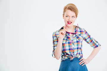 Happy thoughtful woman looking up at copyspace