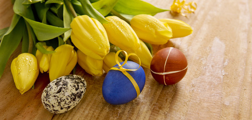 Fototapeta na wymiar Colorful Easter eggs and tulips.