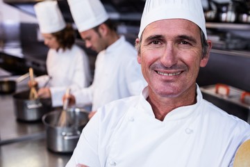 Fototapeta na wymiar Portrait of smiling chef in commercial kitchen