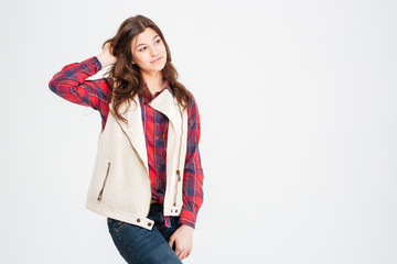 Pensive pretty young woman in plaid shirt and waistcoat