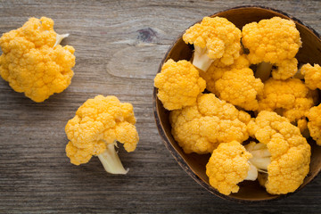 Rainbow of eco cauliflower on the wooden table.