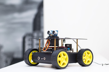 metal robot with wheels stands sideways