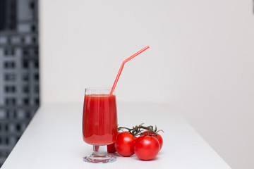 tomato juice in a glass with a straw