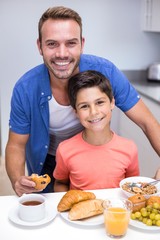 Obraz na płótnie Canvas Father and son having breakfast