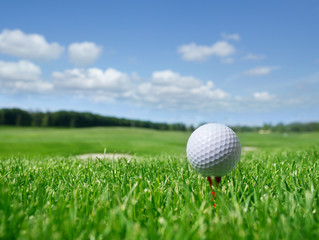 Golf ball on tee in grass