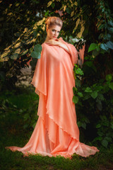 красотка в лесу в персиковом платье