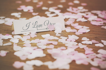 Place tag surrounded by heart shaped confetti