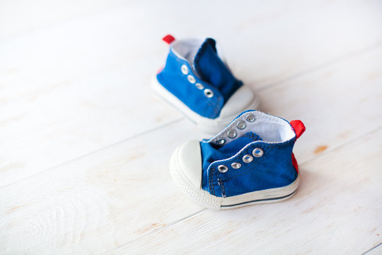 Baby Shoes On Wood Background