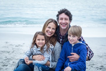 Happy family relaxing at sea shore