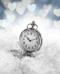 Fototapeta na wymiar Pocket watch over white snow background