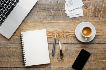 Working place with notebook on wooden table