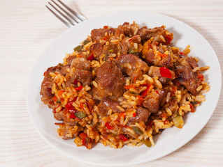 Rice with meat and vegetables on plate