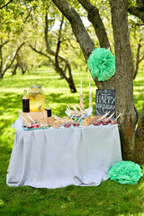 Glass jars of lemonade on wedding candy bar