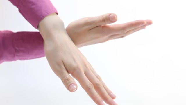 Female hands demonstrating a gesture of prohibition, white background