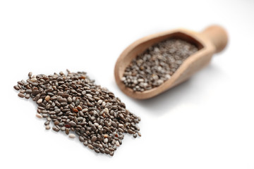 Chia seeds in scoop on white background