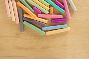 Obraz premium Group colored pastel chalks on a wooden background