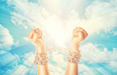 Two hands in chains on a heavens
