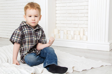 little boy sitting with his fist and threatened