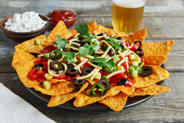  mexican tortilla chips with  cheese  tomato black olives pepper sauce