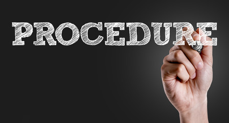 Hand writing the text: Procedure