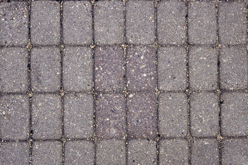 Facing gray tiles as a vintage background. Paving stone texture. Pattern.