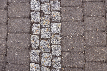 Facing gray tiles as a vintage background. Paving stone texture. Pattern.