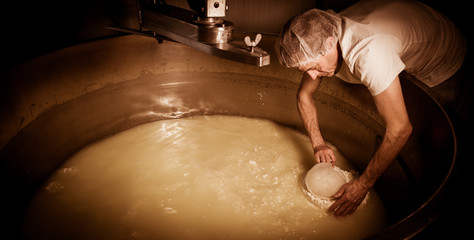 Cheesemaker -Traditional cheese making at a creamery,