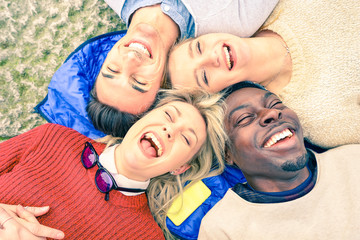 Multiracial best friends having fun and laughing together outdoor at springtime - Happy friendship...
