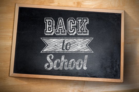 Composite image of back to school against chalkboard