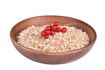 Oatmeal in a bowl with red currants isolated