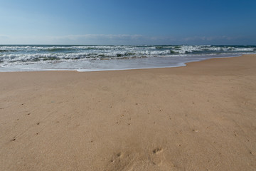 Fototapeta na wymiar Mediterranean sea to the sand and waves