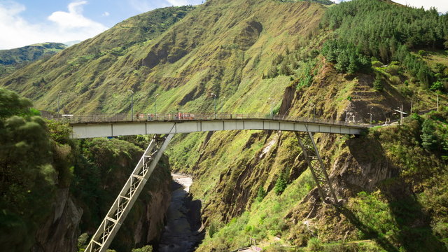 Witness the breathtaking time lapse of San Francisco Bridge in Baños,Ecuador,where an adventurous group of tourists gather for an exhilarating bungee jumping experience.