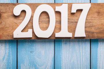 White word of 2017 on wooden background.