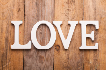Word LOVE on vintage wood background