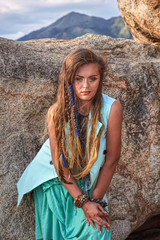 Fashion portrait of young beautiful girl near mountain, boho style