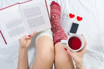 Woman reading a book in bed