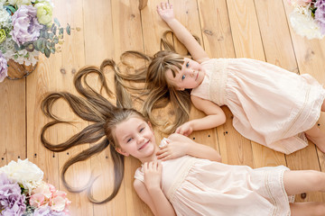 Little sisters of the artist in a floral studio
