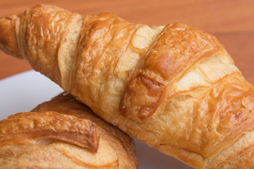 Tasty croissants on wooden background