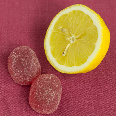 Lemon and candy on the tablecloth.