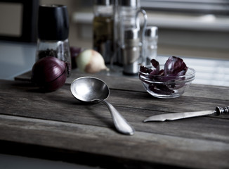 red onion and cutlery on a wooden table