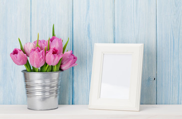 Fresh pink tulips bouquet and photo frame