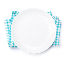 Empty plate over kitchen towel